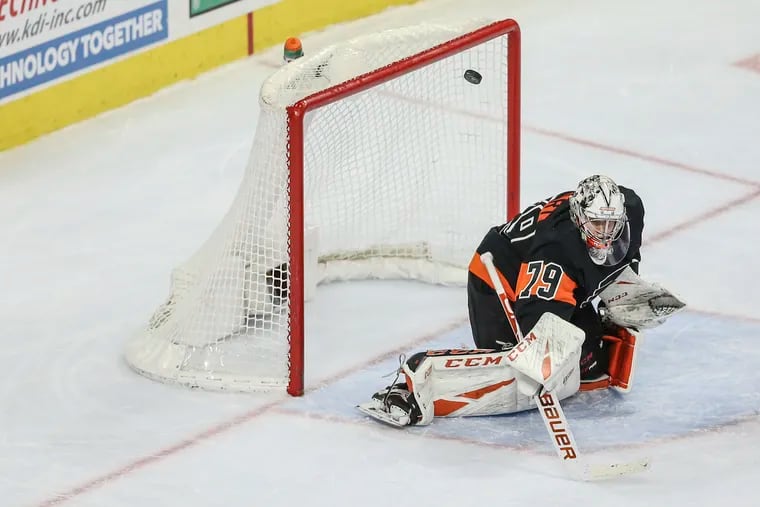 Flyers' goalie Carter Hart deflects a shot on goal by the  Rangers during the second period.