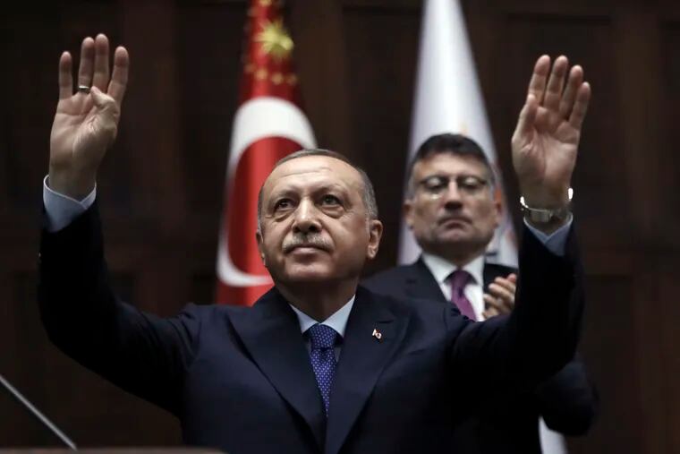 Turkish President Recep Tayyip Erdogan gestures as he addresses his ruling party legislators at the Parliament, in Ankara, Wednesday, Oct 16, 2019.