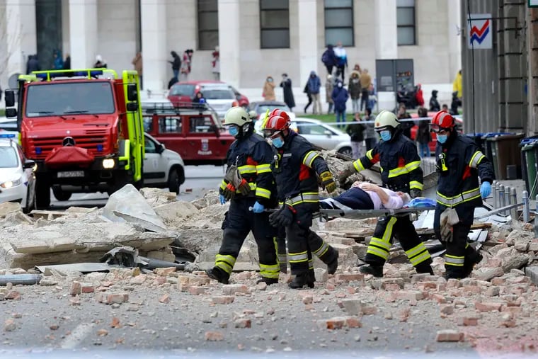 Firefighters carry a person on a stretcher after an earthquake in Zagreb, Croatia, on Sunday.