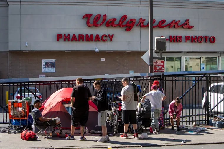 A group of people gather on Kensington Avenue outside a Walgreens in 2021. The pharmaceutical giant agreed to pay the city of Philadelphia $110 million over five years in a settlement of a lawsuit over its role in the opioid crisis.