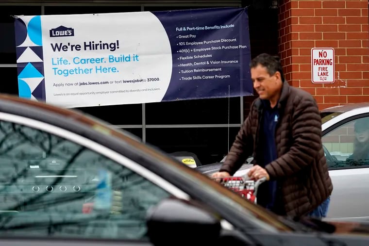 A hiring sign is displayed at a Lowe's home improvement store in Northbrook, Ill., on Thursday.
