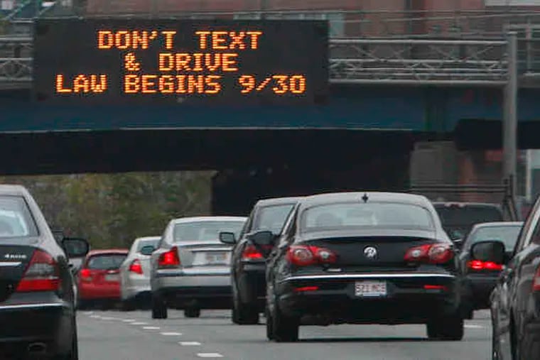 A Massachusetts Turnpike sign near Boston alerts drivers to the new law banning texting while driving. But, as one expert noted, drivers hiding their phones while texting because of the law may be failing to watch the road even more.
