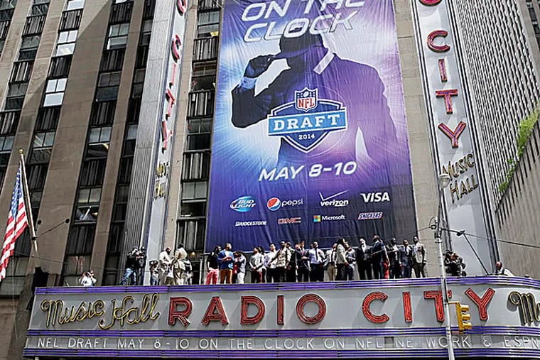 The 2014 NFL draft prospects line up on the awning of Radio City Music Hall. (Seth Wenig/AP)