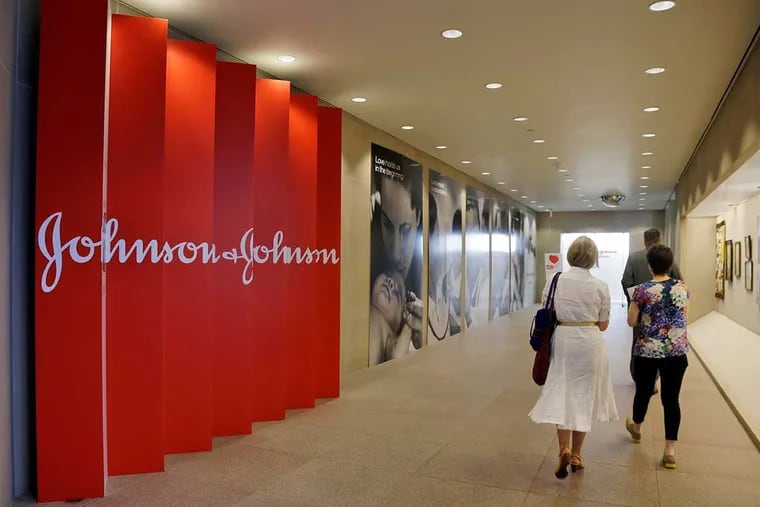 In this July 30, 2013, file photo, people walk along a corridor at the headquarters of Johnson & Johnson in New Brunswick, N.J.