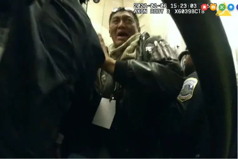 A man prosecutors have identified as Antonio LaMotta, 63, of Chesapeake, Va., is seen on police body cam video being pushed outside of the Capitol building during the Jan. 6, 2021 insurrection.