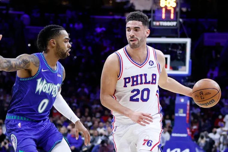Sixers forward Georges Niang dribbles the basketball against Minnesota Timberwolves guard D'Angelo Russell on Saturday, November 27, 2021 in Philadelphia.