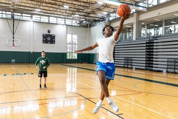 Tyler Sutton, 14, of South Philadelphia, Pa., is doing some shooting drills with coach Ben Luber, at George School in Newtown, Pa., on Tuesday, May, 30 2023.