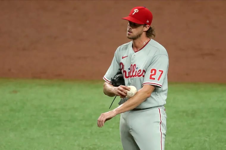Phillies starting pitcher Aaron Nola reacts after giving up a single to Hunter Renfroe to score the third Rays run during the third inning of Sunday's game. The Phillies were eliminated from postseason contention with the loss.