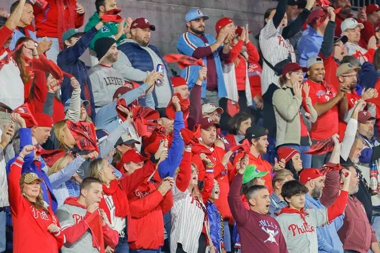 Fans wave rally flags as Philadelphia Phillies players are introduced before Game 7 of the baseball NL Championship Series between the Arizona Diamondbacks and the Philadelphia Phillies on Tuesday, Oct. 24, 2023, at Citizens Bank Park in Philadelphia.