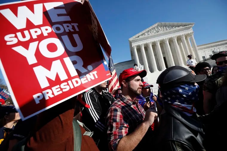 Members of the far-right group Proud Boys rally outside the Supreme Court building in Washington, D.C., on Saturday, Nov. 14, 2020.