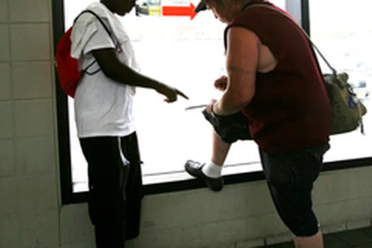 In the downtown Camden PATCO station , Abdoulaye Bah, 13, (left) registers David Ayotte of Camden to vote.