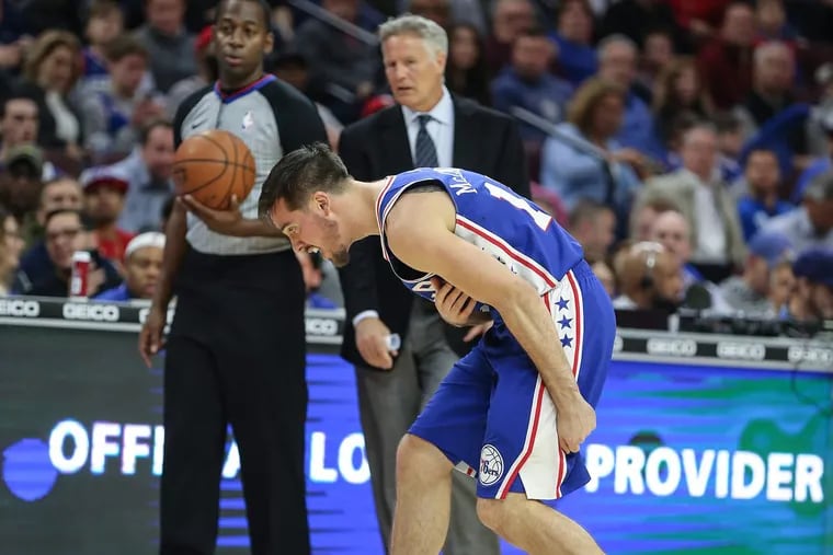 Sixers’ guard T.J. McConnell is injured while playing the Wizards during the third quarter of the Sixers’ win over the Wizards on Wednesday.
