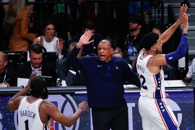 Sixers Head Coach Doc Rivers celebrate his teams game four win over the Brooklyn Nets with players forward Tobias Harris and guard James Harden in the first round Eastern Conference playoffs on Saturday, April 22, 2023 in New York.  The Sixers swept the Nets 4-0 and move on the Eastern Conference semifinals.