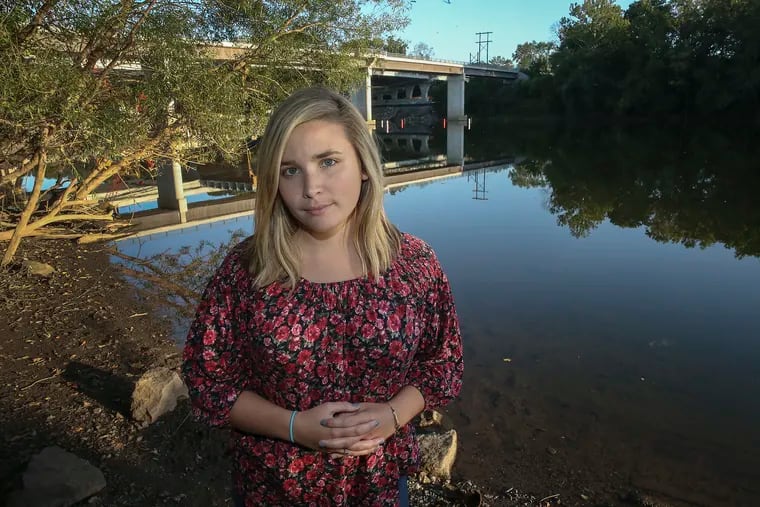 Erin McCarthy stands on the banks of the Schuylkill River near Valley Forge, much closer to home than the Bradford County section of the Susquehanna River where she was trapped for 20 minutes in rushing water this summer.