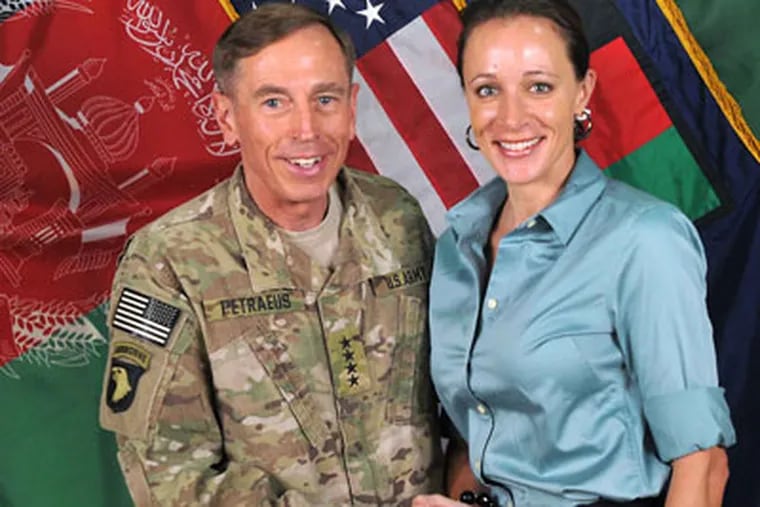 This July 13, 2011, photo made available on the International Security Assistance Force's Flickr website shows the former Commander of International Security Assistance Force and U.S. Forces-Afghanistan Gen. Davis Petraeus, left, shaking hands with Paula Broadwell, co-author of  "All In: The Education of General David Petraeus."As details emerge about Petraeus' extramarital affair with his biographer, Broadwell, including a second woman who allegedly received threatening emails from the author, members of Congress say they want to know exactly when the now ex-CIA director and retired general popped up in the FBI inquiry, whether national security was compromised and why they weren't told sooner. (AP Photo/ISAF)