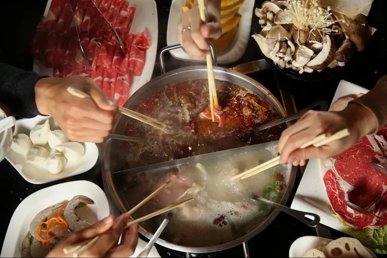 Slices of various meats  cooked in a pot of bubbling broth at Little Sheep Mongolian Hot Pot in Chinatown.