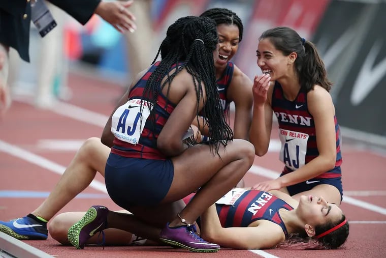 Penn's Maddie Villalba, bottom right, celebrates with her teammates,Uchechi Nwogwugwu, Nia Akins, and Melissa Tanaka, after crossing the finish line in the college women's distance medley championship during the 125th annual Penn Relays at Franklin Field in Philadelphia on Thursday, April 25, 2019. Penn won the event, setting a new Ivy League record.