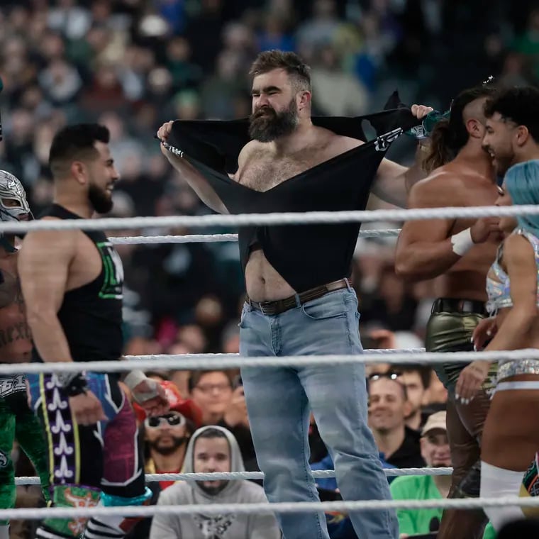 Jason Kelce, center, rips his shirt off in the ring during WrestleMania at Lincoln Financial Field on Saturday, April 6.