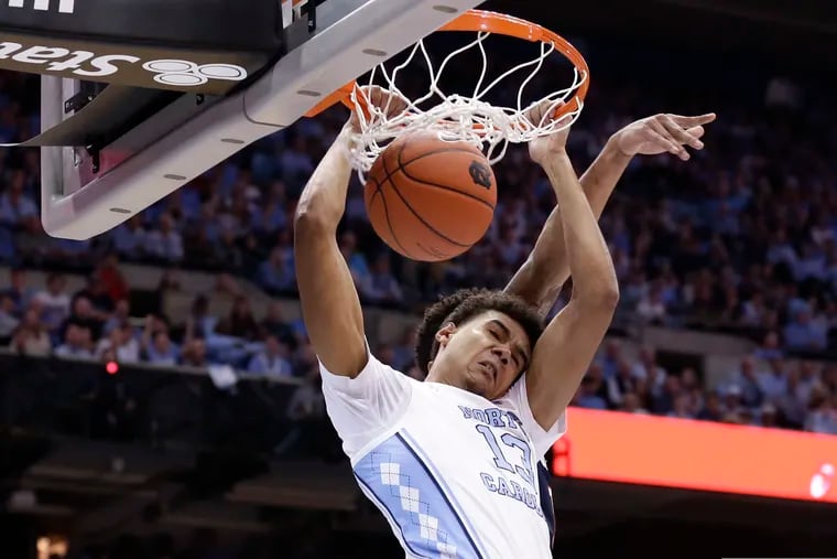FILE - In this Dec. 15, 2018, file photo, North Carolina's Cameron Johnson (13) dunks against Gonzaga during the first half of an NCAA college basketball game, in Chapel Hill, N.C. Johnson was named to the AP All-ACC team, Tuesday, March 12, 2019.(AP Photo/Gerry Broome, File)