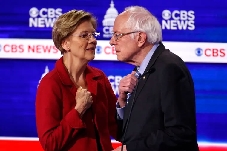 From left, Democratic presidential candidates, Sen. Elizabeth Warren, D-Mass., talks with Sen. Bernie Sanders, I-Vt., during a Democratic presidential primary debate at the Gaillard Center, Tuesday, Feb. 25, 2020, in Charleston, S.C., co-hosted by CBS News and the Congressional Black Caucus Institute.