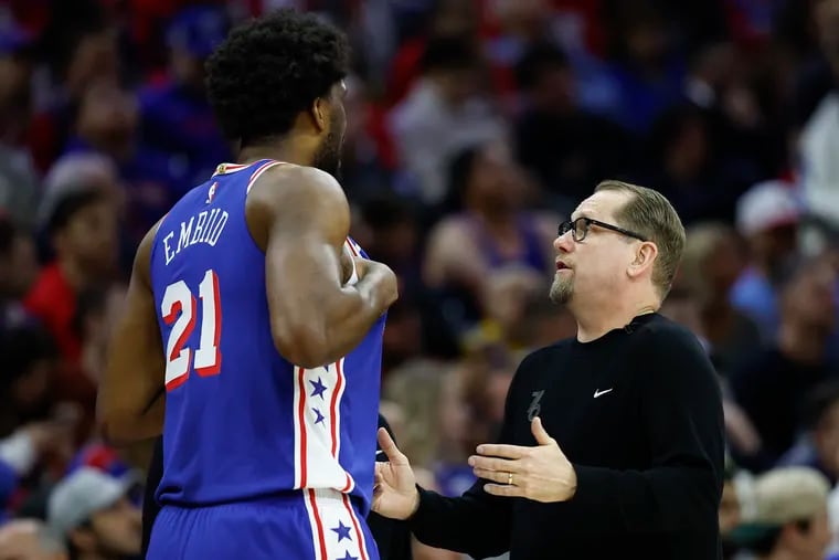 Sixers head coach Nick Nurse (right) frequently checks in with star center Joel Embiid about more than just his physical ability to practice and play.