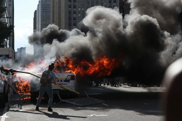 Lore-Elisabeth Blumenthal sets a police vehicle on fire outside of Philadelphia City Hall on May 30, 2020, during a racial justice protest after the killing of George Floyd in Minneapolis.