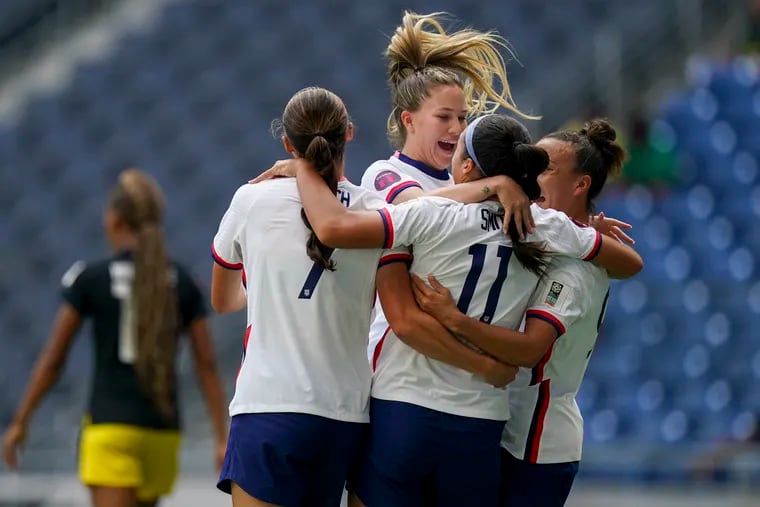 U.S. players celebrate with Sophia Smith (11) after one of her goals against Jamaica.