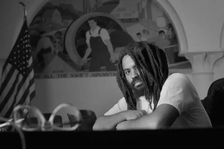 Mumia Abu-Jamam in a rare contact visit with photographer Lou Jones, at the super max prison SCI Huntingdon, PA, a seen in MUMIA: LONG DISTANCE REVOLUTIONARY, a film by Stephen Vittoria. PHOTO: Lou Jones