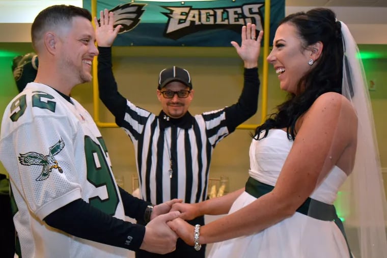Newlyweds Christian and Sabrina Regalbuto with his father Rusty Regalbuto officiating the ceremony pose for pictures after their vows in their Eagles themed wedding at the Bensalem Country Club on Sunday 4,2018. Mark C Psoras/For the Inquirer