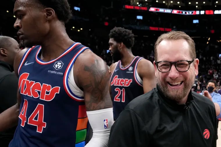 Toronto Raptors coach Nick Nurse walks past the Sixers' Paul Reed (44) and Joel Embiid after Game 6 of their first-round playoff series in 2022.