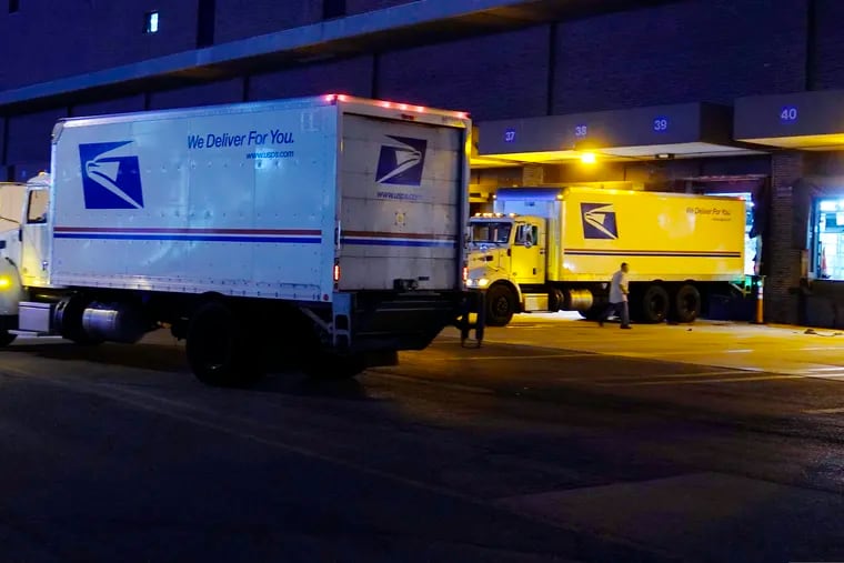 Delivery trucks arrive at the loading dock at the United States Postal Service sorting and processing facility Nov. 18, 2021, in Boston. The Environmental Protection Agency is raising concerns about a U.S. Postal Service plan to replace its huge fleet of mail-delivery trucks, saying the effort does not include enough electric vehicles.