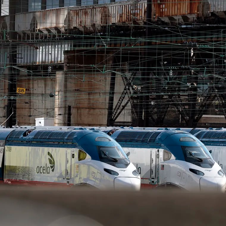 In this file photo, Amtrak Acela trains sit in the Amtrak yard adjacent to 30th Street Station in Philadelphia. Service was temporarily suspended Wednesday night between Philadelphia and New York City.