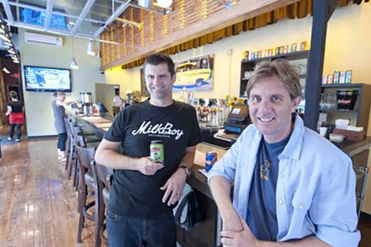 MilkBoy's co-owners, Tommy Joyner (left) and Jamie Lokoff, sit at the bar of their new site at 11th and Chestnut Streets. Besides premium coffee, they will offer music and liquor. (Clem Murray / Staff Photographer)