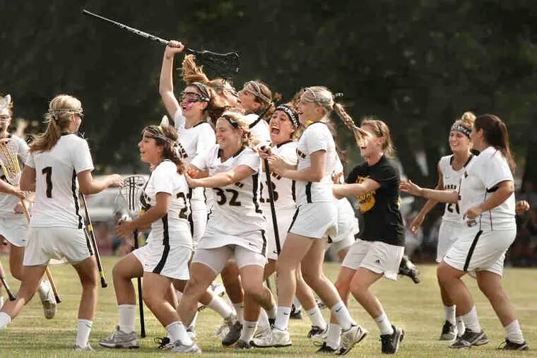 Moorestown players erupt in celebration after the Quakers beat rival Shawnee, 8-5, to win the South Jersey Group 3 crown.