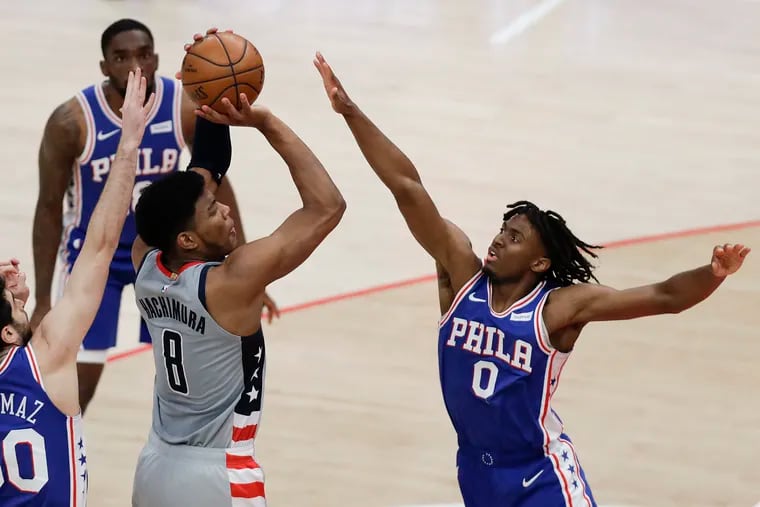 Team defense will be key for the Sixers, who will be without star Joel Embiid for Wednesday's Game 5. Here, Furkan Korkmaz (left) and Tyrese Maxey try to stop Wizards' forward Rui Hachimura in Game 4 on Monday.