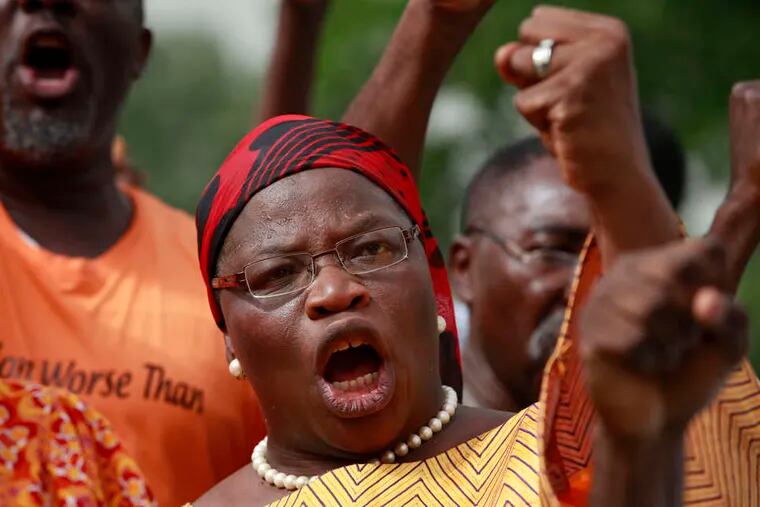 In Abuja, Nigeria's capital , a woman shouts slogans during a rally calling on the government to rescue the schoolgirls kidnapped from a school there last month. SUNDAY ALAMBA / Associated Press