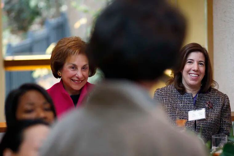 Harriet Weiss (left), who hosted a reception backing Plan W, and Leslie Richards (right), Montgomery County Commissioner, listen as women introduce themselves.