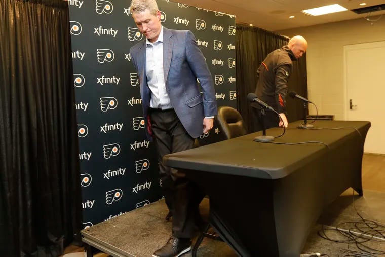 Chuck Fletcher (left), Flyers president of hockey operations, leaves after meeting with the media with interim head coach Mike Yeo after the Flyers announced they have relieved head coach Alain Vigneault and assistant coach Michel Therrien of their duties.