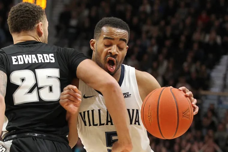 Phil Booth (right), here colliding with Drew Edwards of Providence, has compiled quite a resume in his years at Villanova.