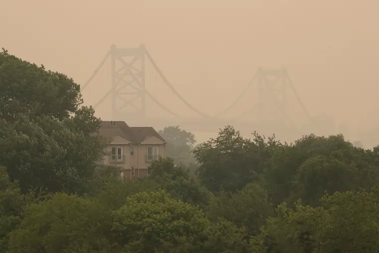 Canadian wildfire smoke obscures the view of the Ben Franklin Bridge and the Philadelphia skyline seen from Cramer Hill Park in Camden on Wednesday.