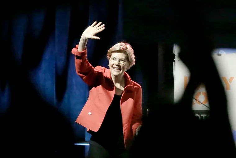 Democratic presidential candidate Elizabeth Warren waves to a cheering crowd before speaking at a forum sponsored by NetRoots at the Pennsylvania Convention Center in Philadelphia on July 13.