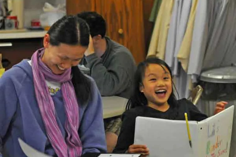 Sarah Mitteldorf working with a group of young Asian adoptees on May 4, 2013 at Reformed Church of the Asuncion in Jeffersonville, PA.  Here, from left to right: Mitteldorf; Lili Tomcavage, 9; and Maya Demitrack, 11.  ( APRIL SAUL / Staff )