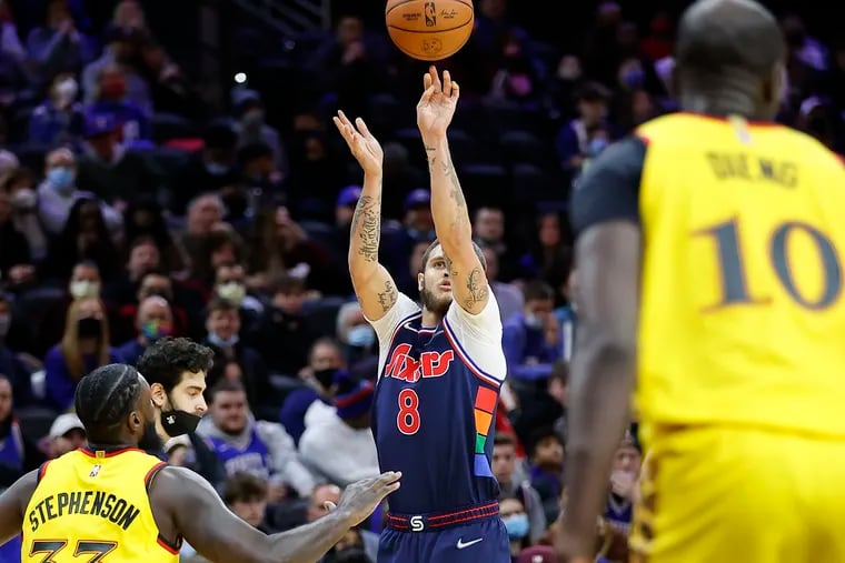 Sixers guard Tyler Johnson shoots the basketball against Atlanta Hawks guard Lance Stephenson on Thursday, December 23, 2021 in Philadelphia.