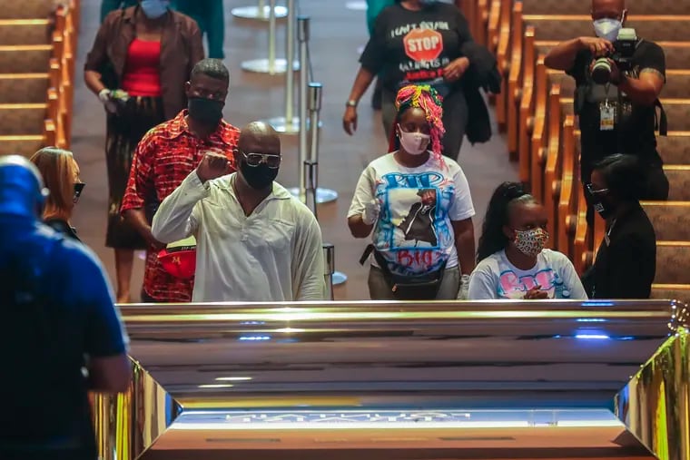 Mourners are guided into the Fountain of Praise Church during a public visitation for George Floyd on Monday in Houston.