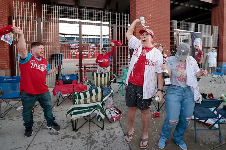 Members of the Phandemic Krew celebrate outside Citizens Bank Park after the Phillies won the first game of a three-game series against the St. Louis Cardinals Oct. 7.