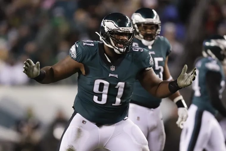 Fletcher Cox raises his arms during the Eagles’ 15-10 NFC Divisional Playoff win against the Atlanta Falcons on Saturday, Jan. 13