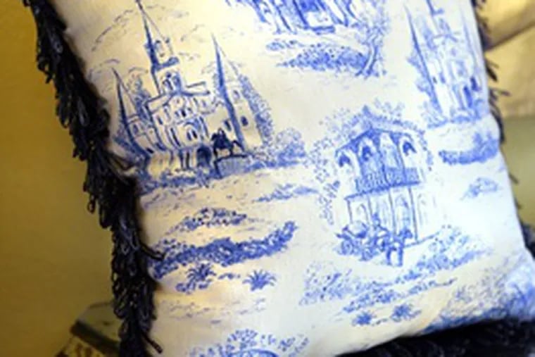 Toile pillow from Hazelnut New Orleans depicts street scenes. Sales have been brisk since Hurricane Katrina.