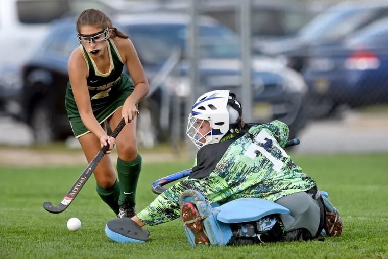 Seneca’s Olivia Quagliero (left) scores against Timber Creek goalie Sarah Cortes (right) in the first half of Tuesday’s field hockey game at Timber Creek.
