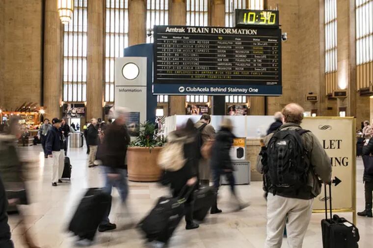 Travelers wait for their trains at 30th Street Station. (Colin Kerrigan / Philly.com)