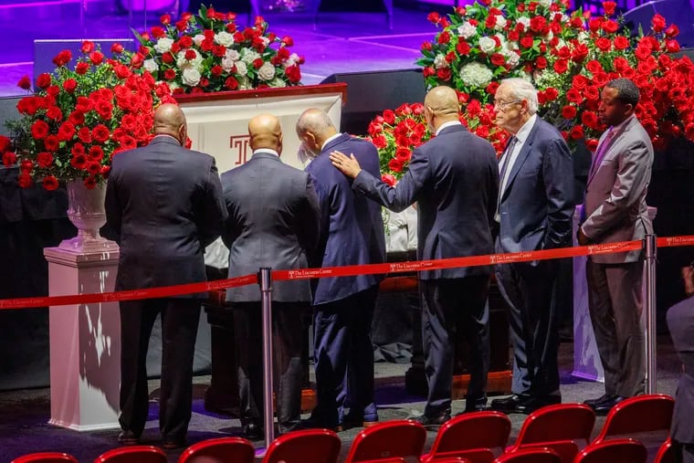 L. Harrison Jay (third from left), husband of the late JoAnne A. Epps, stands beside her casket at a service held at the Liacouras Center on Temple's campus Friday.